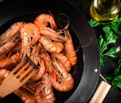 Pot of cooking shrimp with parsley.